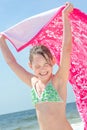Girl on beach with towl Royalty Free Stock Photo