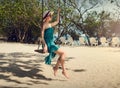 A girl on the beach in yoga Virabhadrasana pose. Yoga at sunrise.