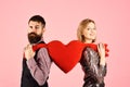 Girl and bearded man with smiling faces divide toy heart