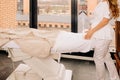 a girl beautician in a white suit stands in a beauty salon near the couch, horizontal image Royalty Free Stock Photo