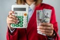 girl in beautiful clothes happy to hold a lot of money in her hands isolated. Royalty Free Stock Photo