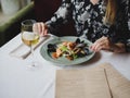 A girl in a beautiful dress is eating a delicious seafood dish in a beautiful restaurant. Perfect time, tasty food. Royalty Free Stock Photo