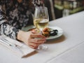 A girl in a beautiful dress is eating a delicious seafood dish in a beautiful restaurant. Perfect time, tasty food. Royalty Free Stock Photo