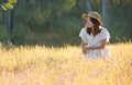 A girl in a beautiful grass flower field