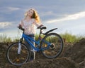 The girl with beautiful hair on a bicycle