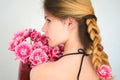 A girl with a beautiful hairdress with a bouquet of tulips is a sort of Columbus Royalty Free Stock Photo