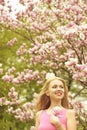 Girl in beautiful magnolia flowers pink color tree Royalty Free Stock Photo