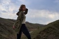 Girl on beautiful mountain view feeling free with wind and sky.  woman on nature background, freedom, post apocalyps Royalty Free Stock Photo