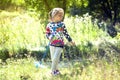 Girl in the beautiful park, with a net catches butterflies, smiles and laughs, playful mood, childish pranks Royalty Free Stock Photo