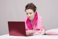 Girl in bed concentrated works for laptop Royalty Free Stock Photo