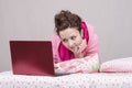 Girl in bed playing with the laptop Royalty Free Stock Photo