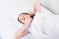 Girl in bed, on a white background, yawns, mouth wide open Royalty Free Stock Photo