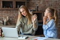 Girl begging her busy mom for attention Royalty Free Stock Photo