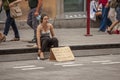 Girl begs on the sidewalk