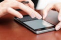 The girl behind the Desk with a smartphone and stylus Royalty Free Stock Photo