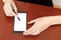 The girl behind the Desk with a smartphone and stylus. Royalty Free Stock Photo