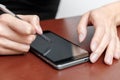 The girl behind the Desk with a smartphone and stylus. Royalty Free Stock Photo