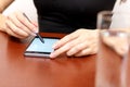 The girl behind the Desk with a smartphone and stylus. Royalty Free Stock Photo