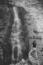 A girl from behind looks at a huge waterfall Royalty Free Stock Photo