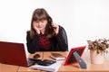 Girl behind office desk listening to cry of the phone Royalty Free Stock Photo