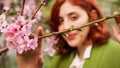 .Girl behind pink flowers Tree. Royalty Free Stock Photo