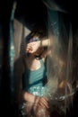 The girl behind the plastic wrap. Conceptual photo of despair and loneliness