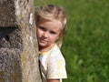 Girl behind the Stone Bollard Royalty Free Stock Photo