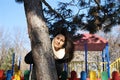 Girl behind tree in park