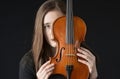 Girl behind violin Royalty Free Stock Photo