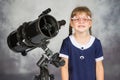 Girl bespectacled amateur astronomer funny smiling standing by telescope