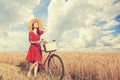 Girl with bicycle on field. Royalty Free Stock Photo