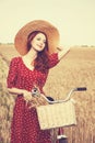 Girl with bicycle on field. Royalty Free Stock Photo