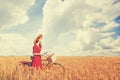 Girl with bicycle on field. Royalty Free Stock Photo