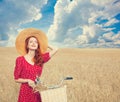 Girl with bicycle on field. Royalty Free Stock Photo