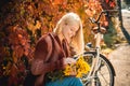 Girl with bicycle and flowers. Woman bicycle autumn garden. Active leisure and lifestyle. Autumn simple pleasures. Girl Royalty Free Stock Photo