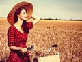 Girl with bicycle on wheat field. Royalty Free Stock Photo