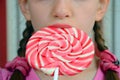 Girl with a big candy lollipop Royalty Free Stock Photo