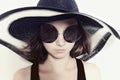 Girl in big round sunglasses and summer hat Royalty Free Stock Photo