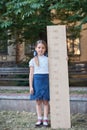 girl with big ruler standing on park background. Farewell Bell. day of knowledge. beginning of the school year. education and Royalty Free Stock Photo