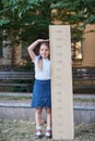 Girl with big ruler standing on park background. Farewell Bell. day of knowledge. beginning of the school year. education and scho Royalty Free Stock Photo