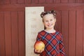 girl with big ruler standing on red wooden background. Farewell Bell. day of knowledge. beginning of the school year Royalty Free Stock Photo