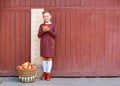 girl with big ruler standing on red wooden background. Farewell Bell. day of knowledge. beginning of the school year Royalty Free Stock Photo