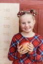 girl with big ruler standing on red wooden background. Farewell Bell. day of knowledge. beginning of the school year Royalty Free Stock Photo