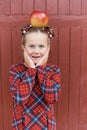 girl with big ruler standing on red wooden background. Farewell Bell. day of knowledge. beginning of the school year Royalty Free Stock Photo