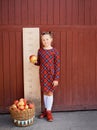 girl with big ruler standing on red wooden background. Farewell Bell. day of knowledge. beginning of the school year Royalty Free Stock Photo