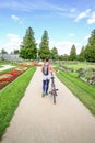 Girl with bike in flower garden of Lednice chateau in South Moravia Ã¢â¬â UNESCO (Czech Republic