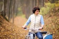 The girl on a bike from the rental in the forest. Girl in a yellow autumn forest. Royalty Free Stock Photo