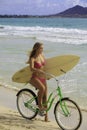Girl with bike and surfboard Royalty Free Stock Photo