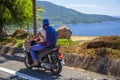 Girl biker riding a scooter in the mountains of Vietnam, Woman in blue helmet riding scooter motorbike, Female traveler riding a