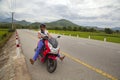 Girl biker riding a scooter in the mountains of Vietnam, Woman in blue helmet riding scooter motorbike, Female traveler riding a